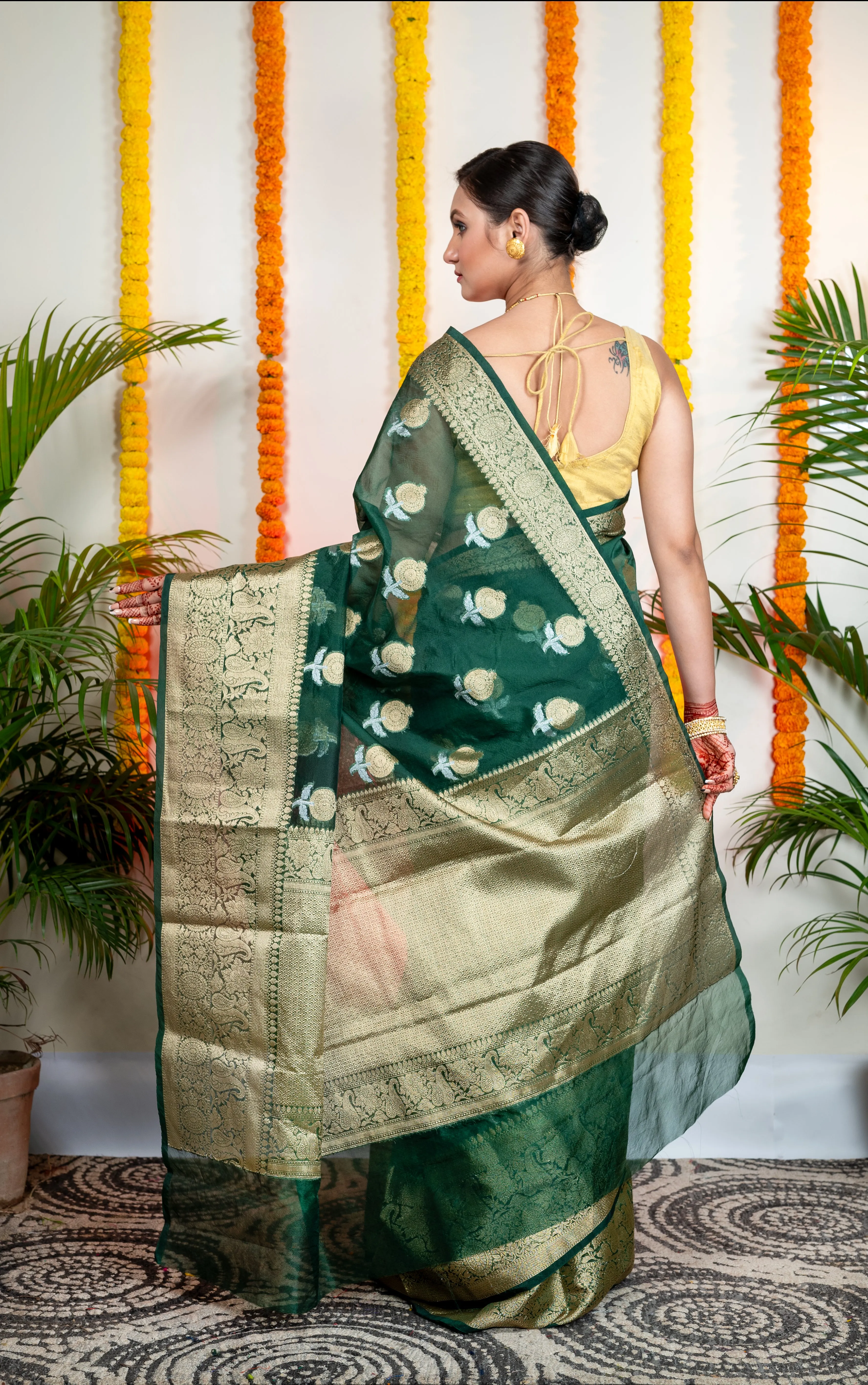 Women Green Organza Silk Saree With Zari Border And Floral Motifs