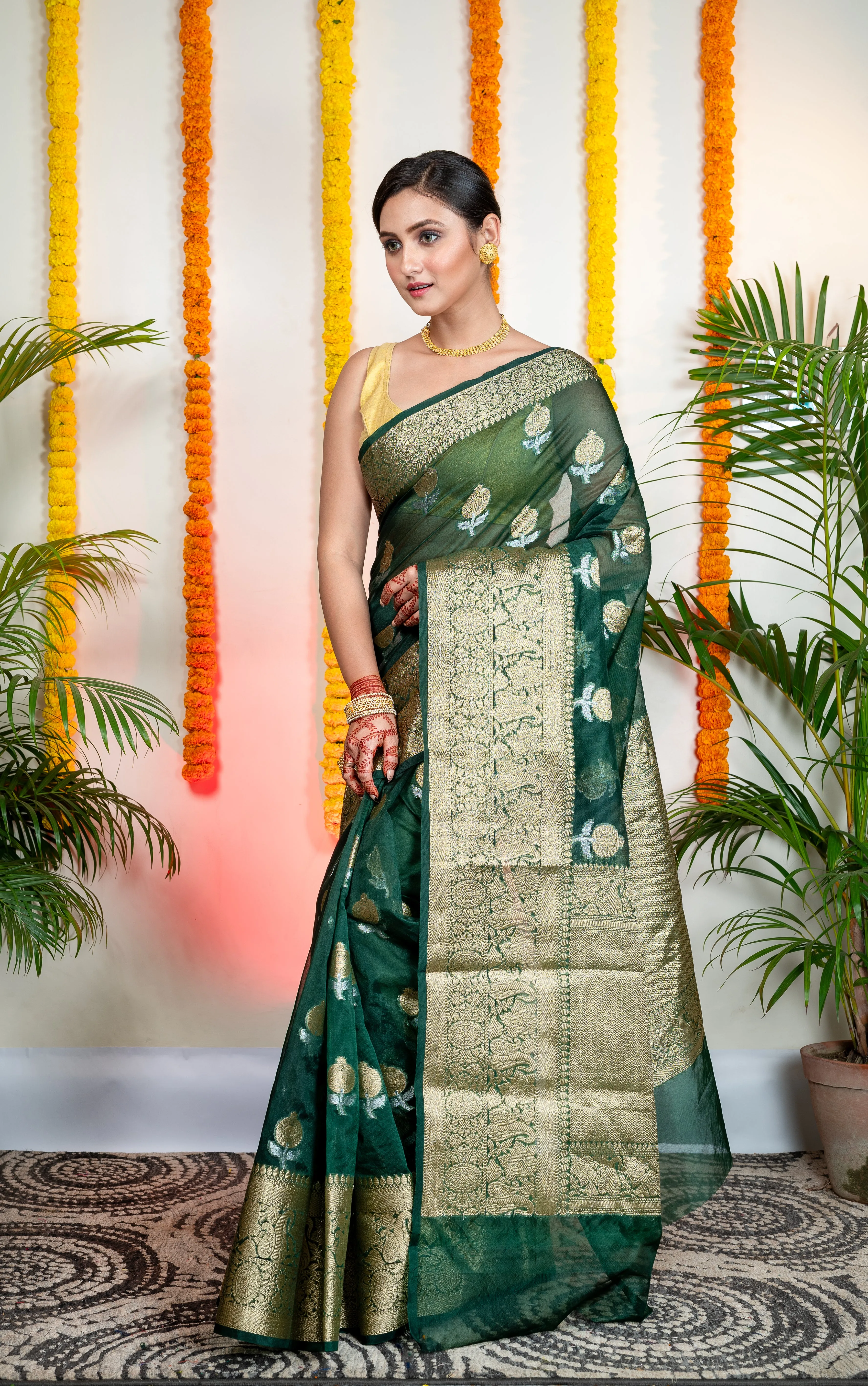 Women Green Organza Silk Saree With Zari Border And Floral Motifs